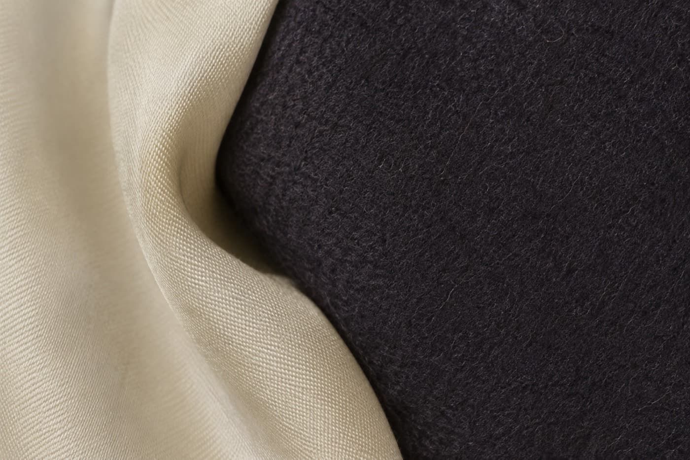 Macro photograph of the folded edge where a silky lining meets a wool facing