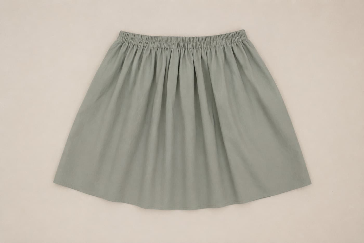 A finished elastic-waist skirt, laid out flat
